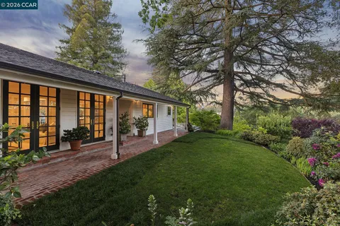 a view of a house with backyard and porch