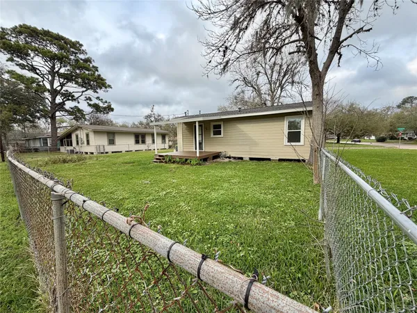a view of a house with a yard and sitting area