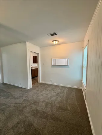 an empty room with a empty space and windows