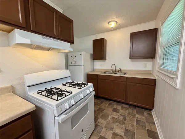a kitchen with a stove and a sink