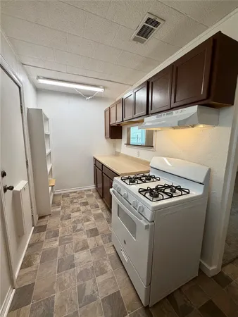 a kitchen with a stove and a refrigerator