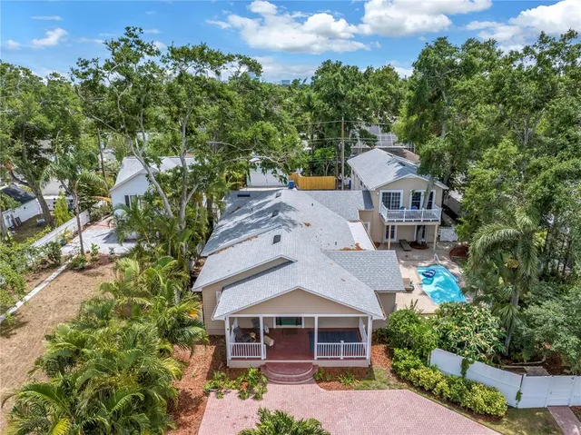 an aerial view of a house with a yard