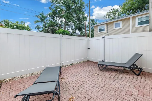 a hallway with white cabinets and wooden floor