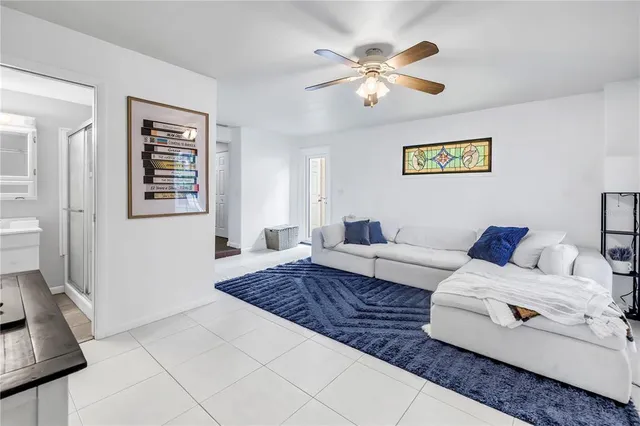 a room with furniture pool table and window