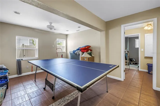 a living room with furniture a window and gym equipment