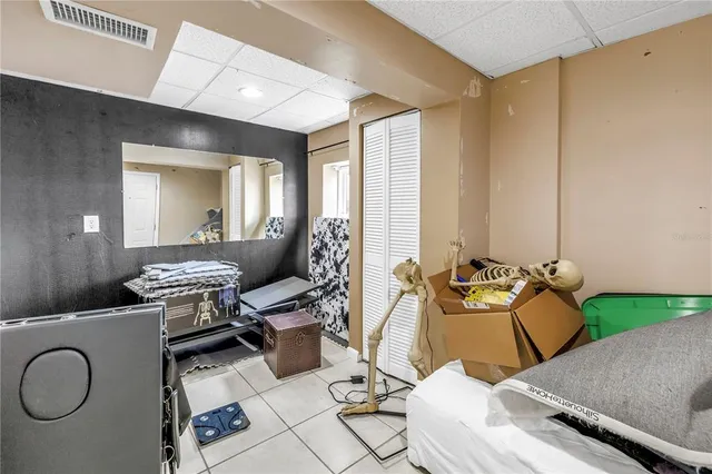 a bedroom with a large bed and a chandelier