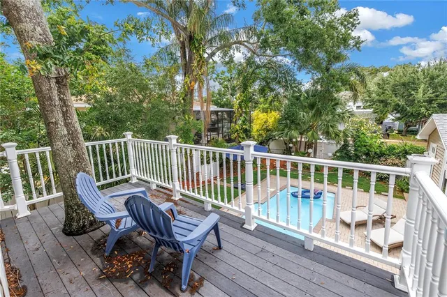 a view of a house with swimming pool and sitting area