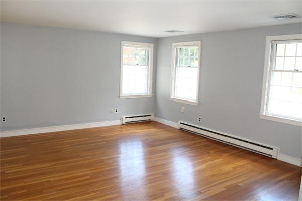 1 Bushnell Drive Lexington, MA 02421 - Photo 13 of 20 an empty room with wooden floor and windows