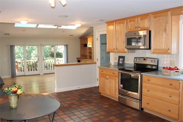 1 Bushnell Drive Lexington, MA 02421 - Photo 8 of 20 a kitchen with stainless steel appliances a stove a sink dishwasher and a microwave with wooden floor
