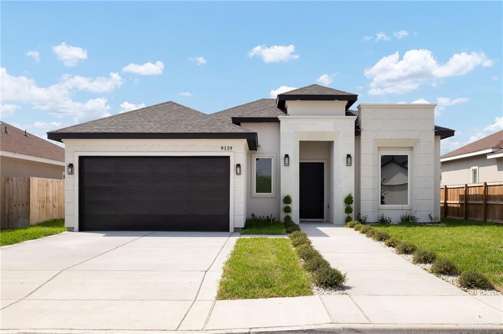 9119 North 25th Street McAllen, TX 78504 - Photo 1 of 22 a front view of a house with a yard and garage