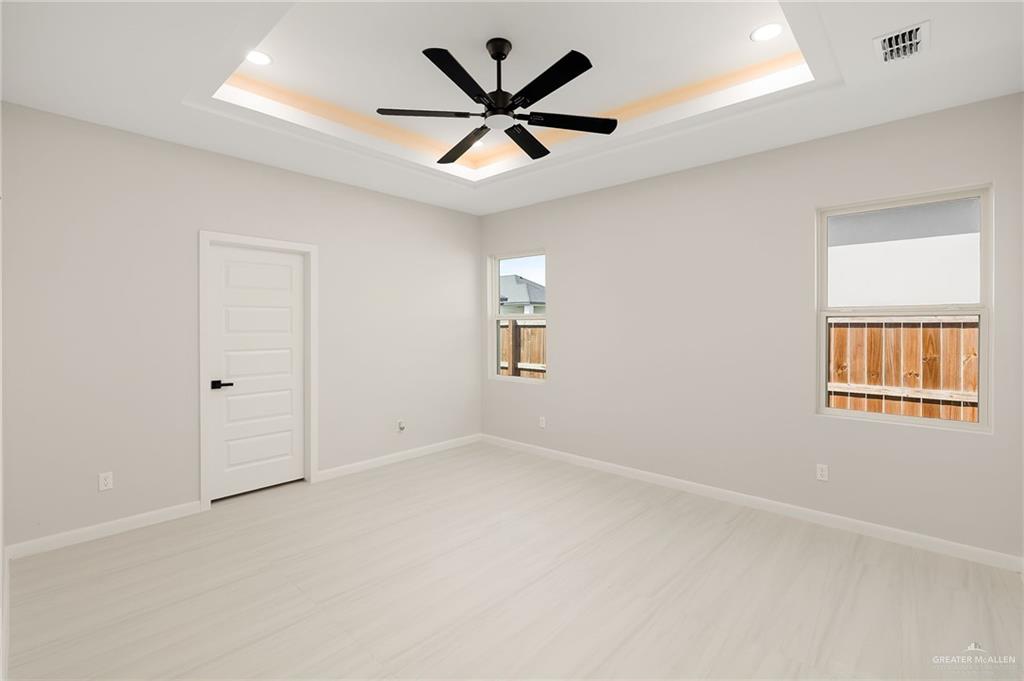 9119 North 25th Street McAllen, TX 78504 - Photo 16 of 22 an empty room with windows and ceiling fan