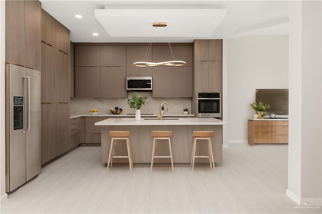 9119 North 25th Street McAllen, TX 78504 - Photo 7 of 22 a kitchen with a sink and chairs
