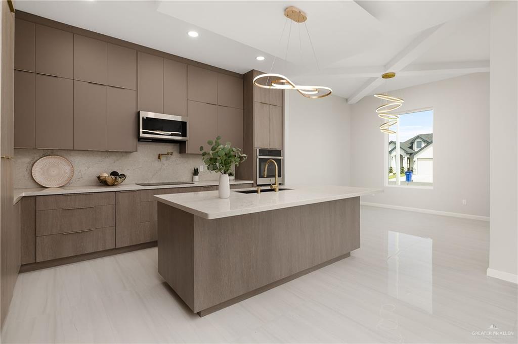 9119 North 25th Street McAllen, TX 78504 - Photo 10 of 22 a kitchen with kitchen island cabinets and oven