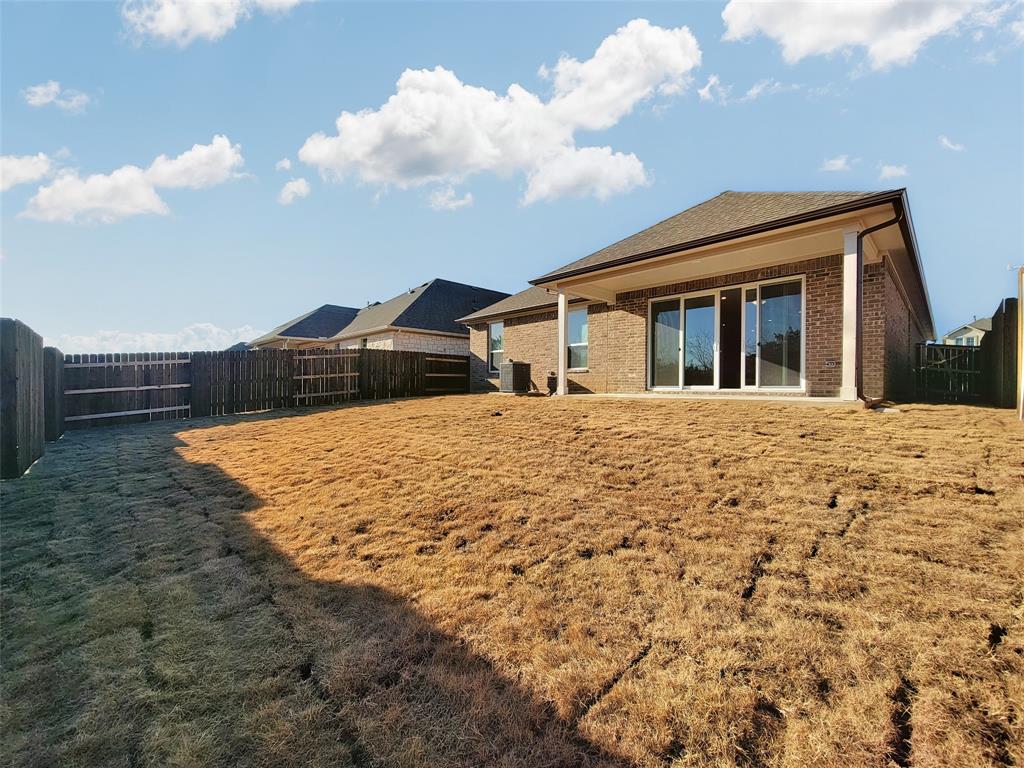 2032 Bobtail Pass Leander, TX 78641 - Photo 17 of 18 a front view of a house with garden