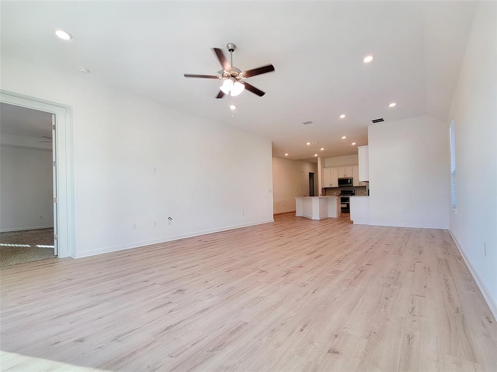 2032 Bobtail Pass Leander, TX 78641 - Photo 6 of 18 a view of empty room with wooden floor and a ceiling fan