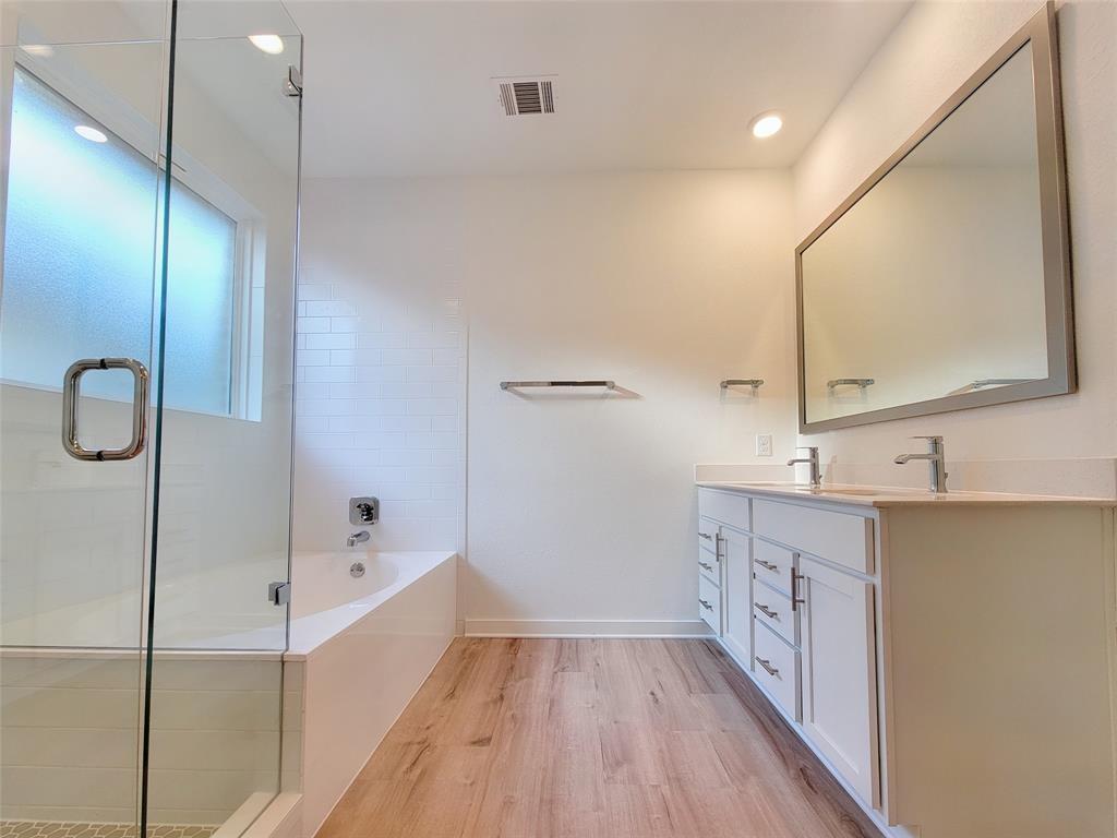 2032 Bobtail Pass Leander, TX 78641 - Photo 8 of 18 a bathroom with a sink a mirror and a bathtub