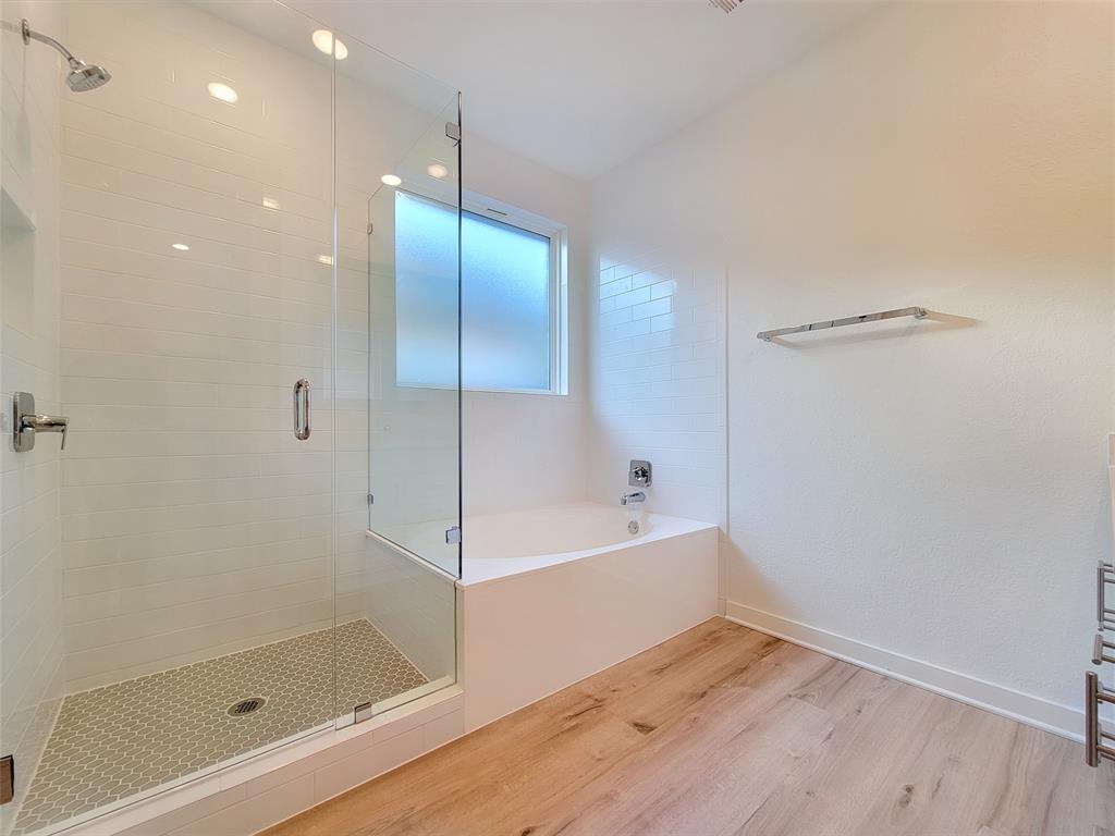 2032 Bobtail Pass Leander, TX 78641 - Photo 9 of 18 a bathroom with a bathtub and a shower