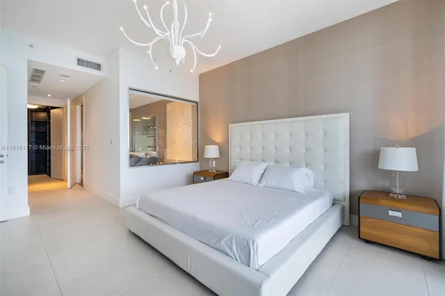 a bedroom with a bed and a view of bedroom