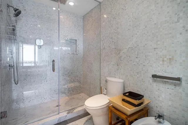 a bathroom with a toilet a sink and shower