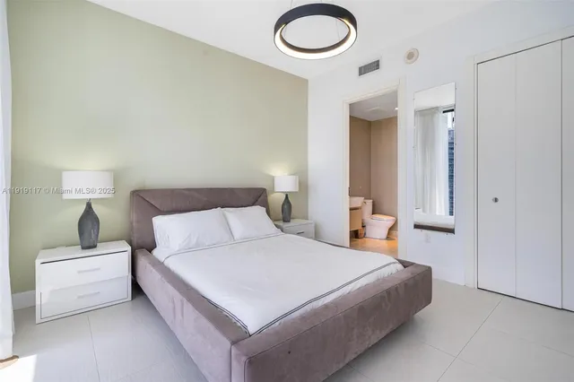 a bedroom with a bed and a lamp