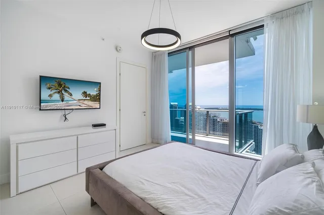 a bedroom with a large bed and a window