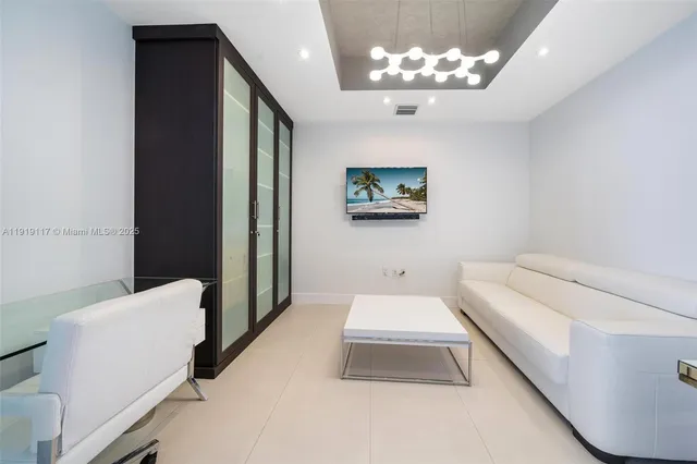 a bathroom with a tub sink and a chandelier