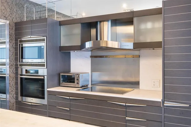 a kitchen with granite countertop a oven and a refrigerator