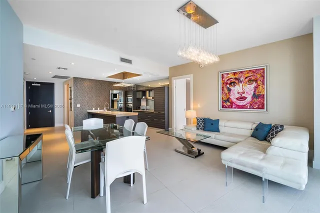 a living room with furniture kitchen view and a table