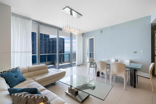 a living room with furniture a table and a window