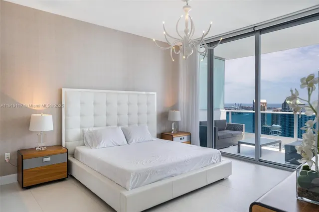 a bedroom with a bed and a chandelier