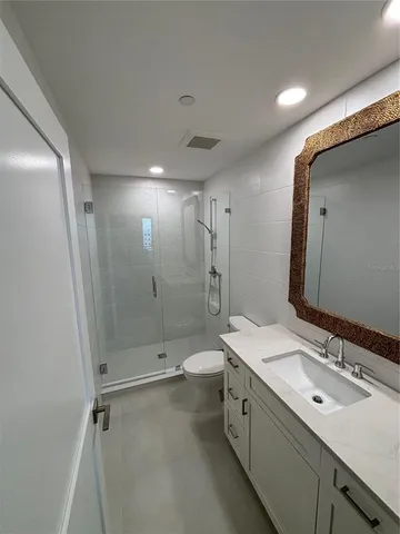 a bathroom with double vanity and a mirror