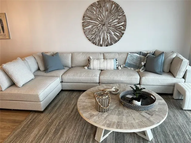 a living room with furniture and a chandelier