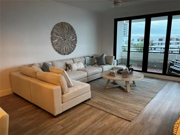 a living room with furniture and a chandelier