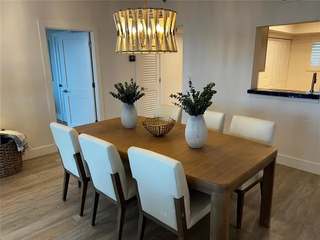 a view of a dining room with furniture wooden floor and a chandelier