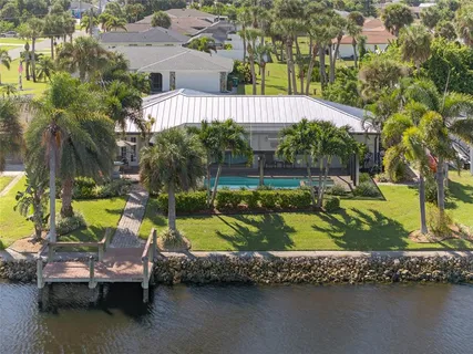 an outdoor sitting area with swimming pool and lake view