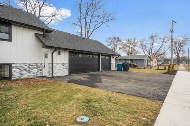 a view of a house with a yard and garage