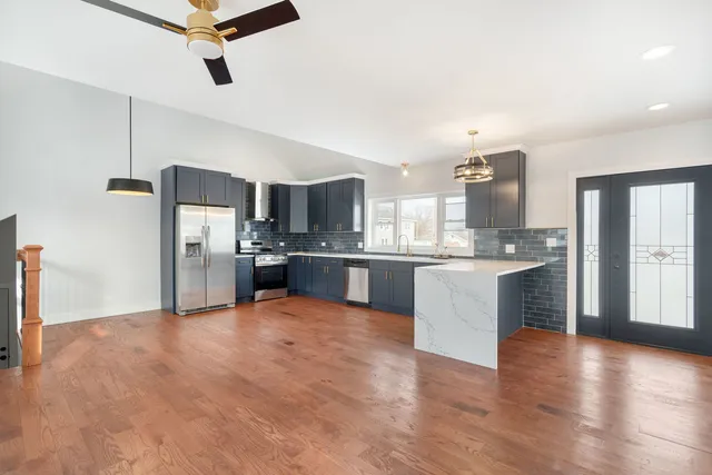 a large kitchen with a refrigerator and a sink