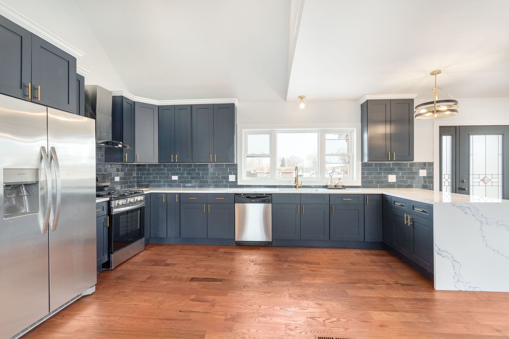 718 East 152nd Street Harvey, IL 60426 - Photo 6 of 33 a large kitchen with stainless steel appliances granite countertop a refrigerator a sink dishwasher a stove with wooden cabinets and floor