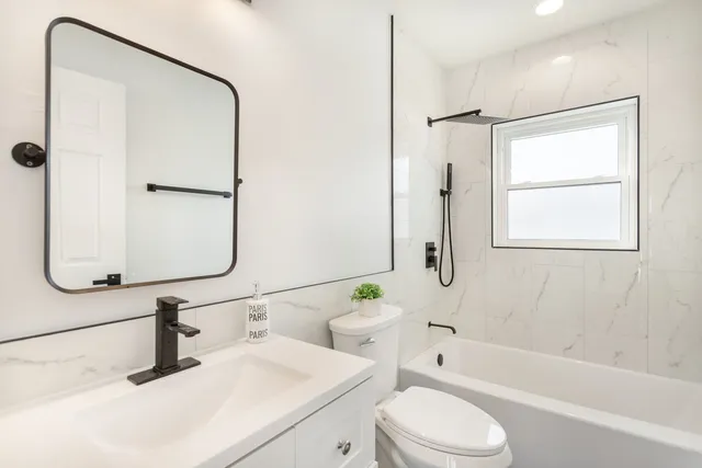 a bathroom with a sink toilet and shower