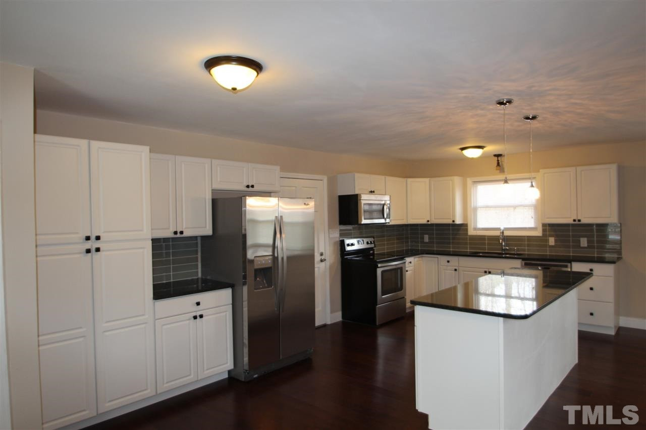 6225 Doyle Road Durham, NC 27712 - Photo 3 of 16 Completely updated kitchen with cabinets, granite counter tops, stainless steel appliances and hardwood floors Kitchen