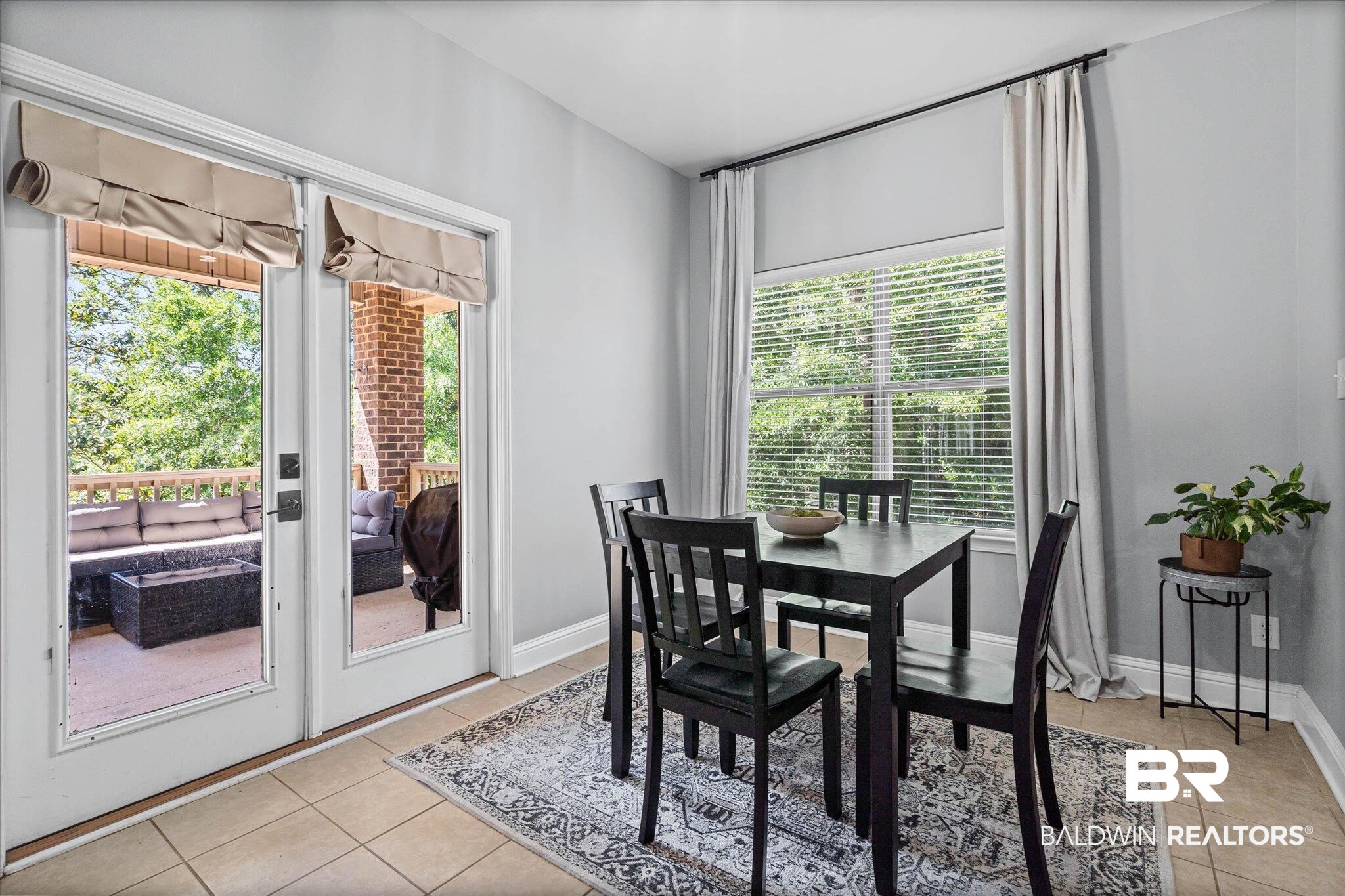 3739 Whitestone Drive Semmes, AL 36575 - Photo 11 of 25 Dining area featuring tile flooring, a large window with blinds, and double glass-paneled doors leading to an outdoor patio with brick columns