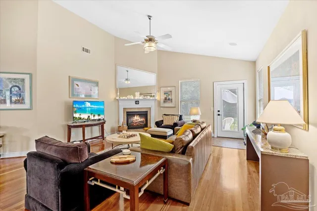 a living room with furniture a fireplace and a flat screen tv