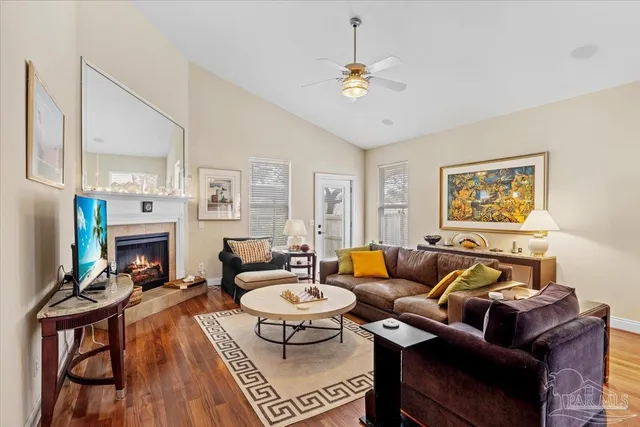 a living room with furniture a fireplace and a flat screen tv