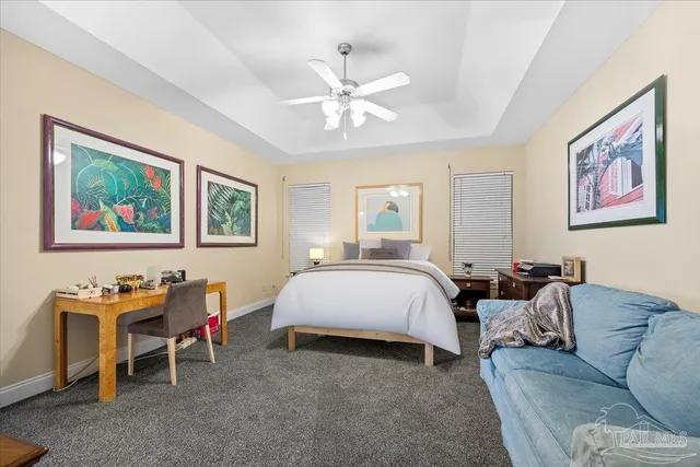 a spacious bedroom with a bed and a chandelier