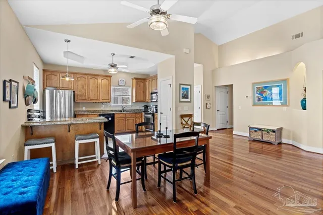 a view of a dining room with furniture and wooden floor