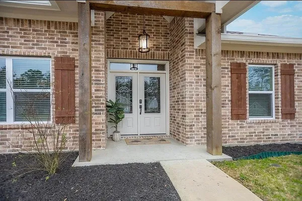 a view of entrance of the house with a yard