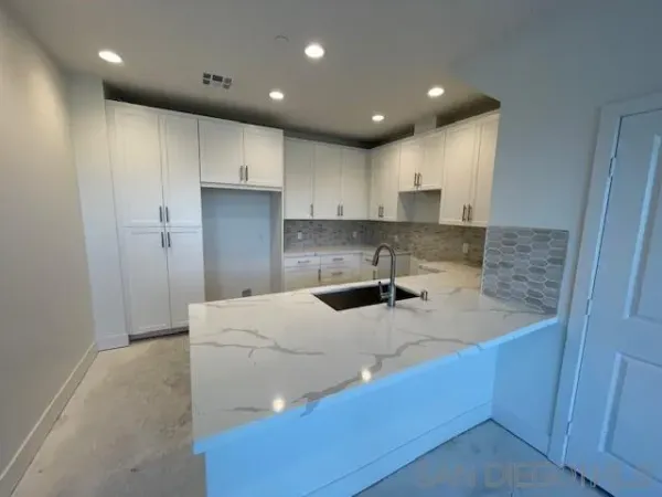 a kitchen with a sink a stove and refrigerator