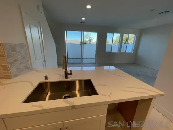 a kitchen with a sink and large window