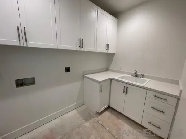 a large kitchen with kitchen island a sink stainless steel appliances and a counter top