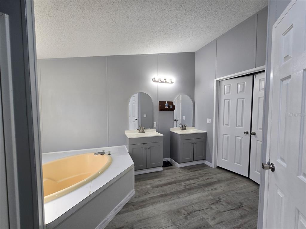 55921 Fern Road Astor, FL 32102 - Photo 12 of 24 a bathroom with a tub sink and mirror